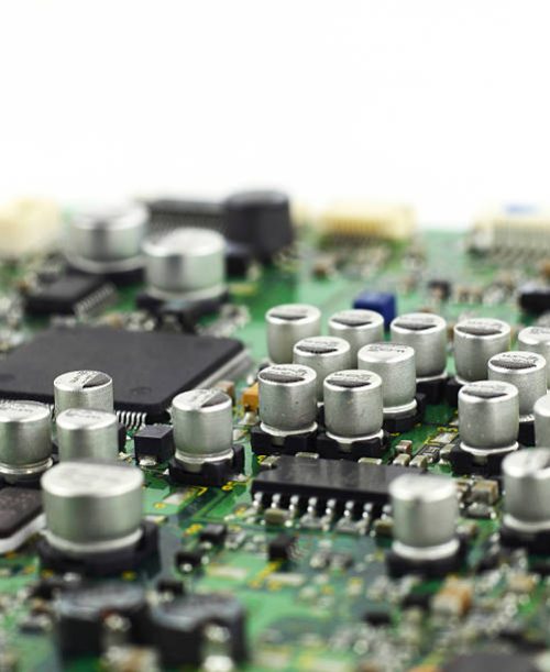 Digital hardware closeup. Microchips and condensers assembly on the circuit board macro